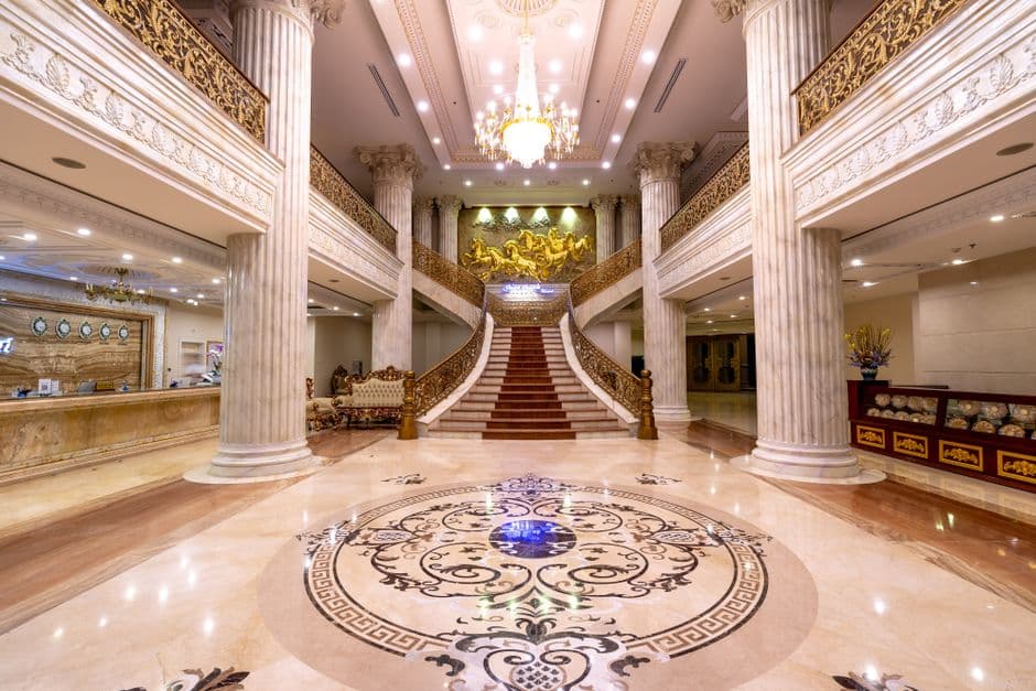 Luxury hotel lobby with elegant interior design and chandelier.
