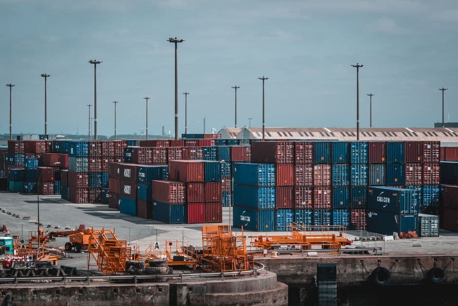 Warehouse logistics with stacked shipping containers.