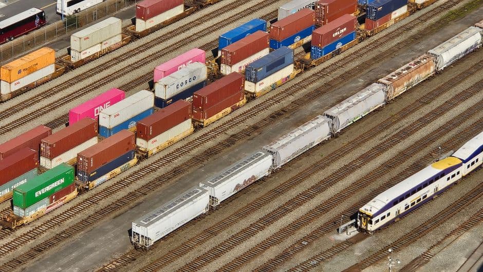 Aerial view of industrial logistics hub with trucks and warehouses.