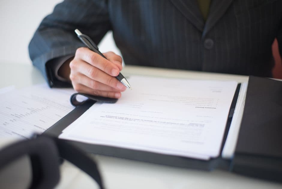 Legal professional reviewing documents in modern office.