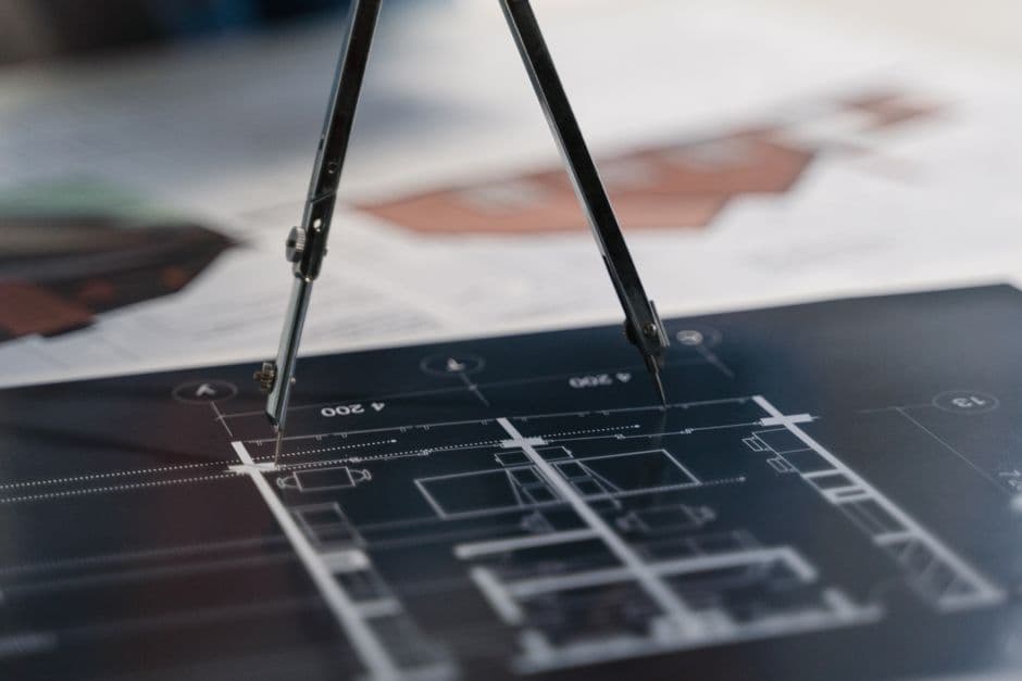 Engineering technical drawing on blueprint at drafting desk.