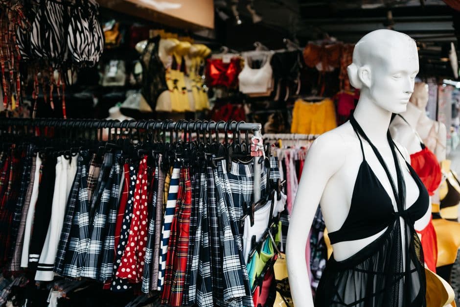 Clothing boutique with fashion display and mannequins.