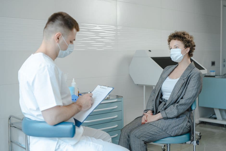 Doctor consulting with patient in a modern hospital room.