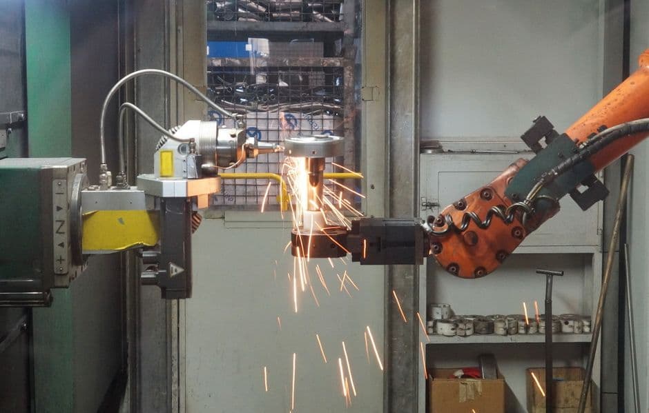 Industrial robotic welding automation in manufacturing facility.