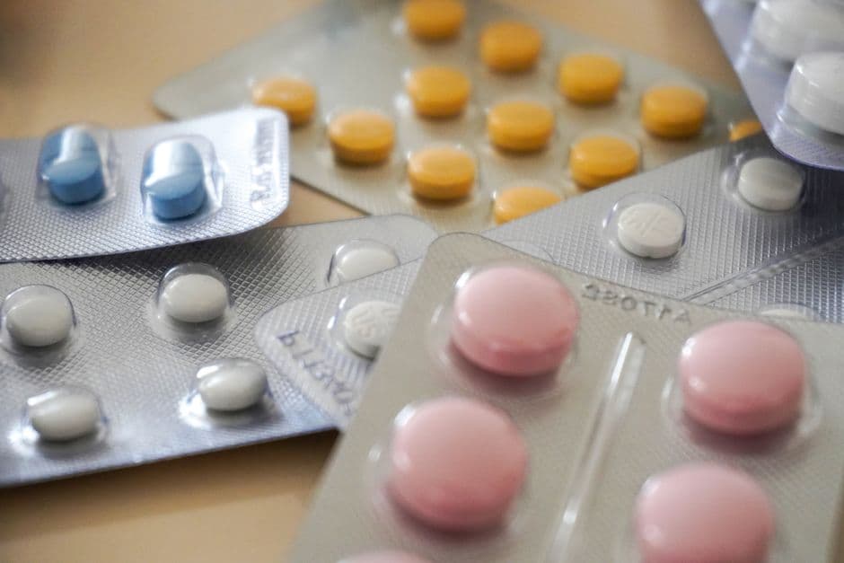 Pills and medication arranged at a pharmacy counter.